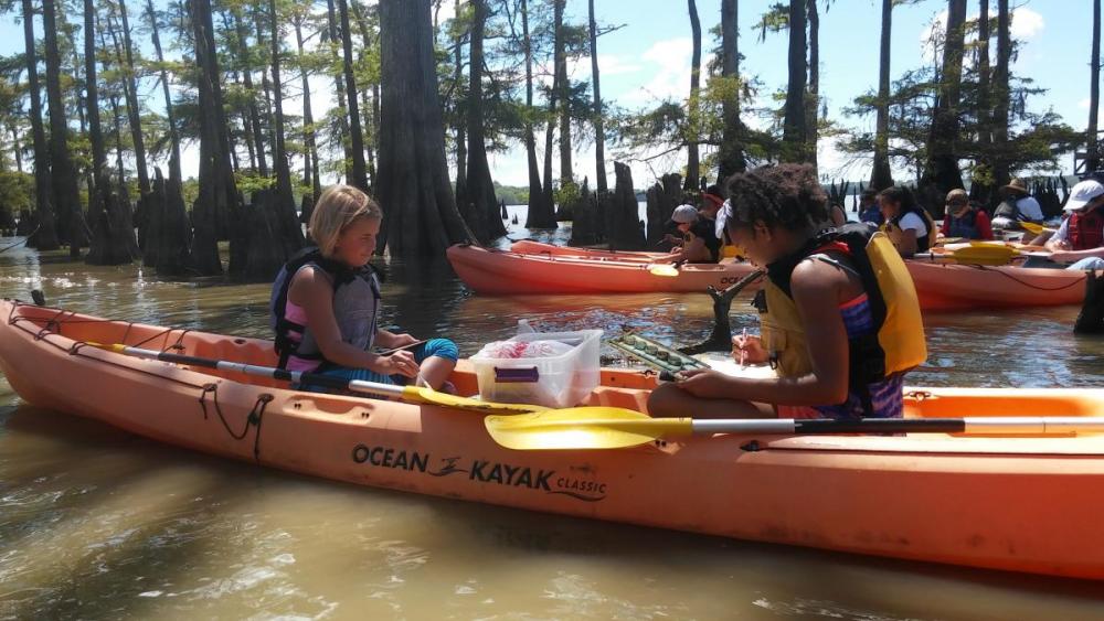 Students kayaking on river