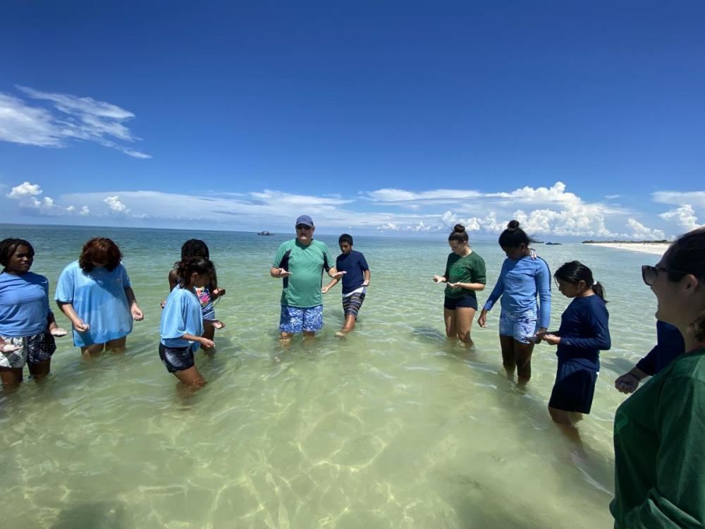 Educator teaches water quality and sea-level rise to Project WATERS participants.