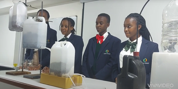 Students from Nova Pioneer Tatu Girls School in Kenya demonstrate their water filtration system 