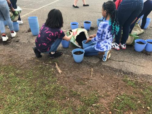 Students working on an action project to equip their school’s classrooms with herb and vegetable planters to educate their fellow classmates on how to grow their own food to minimize plastic usage and marine debris. Photo credit: Lilly Meighan