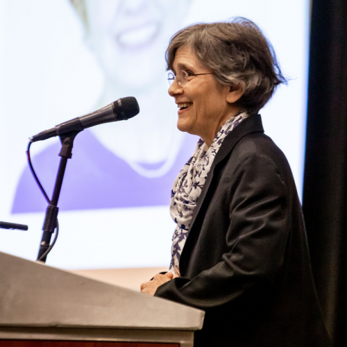 Dr. Marianne Krasny Speaking at a Podium